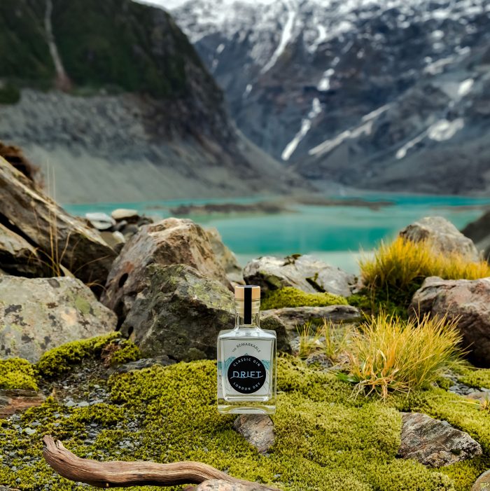 The Remarkables Mini bottle sitting by the lake