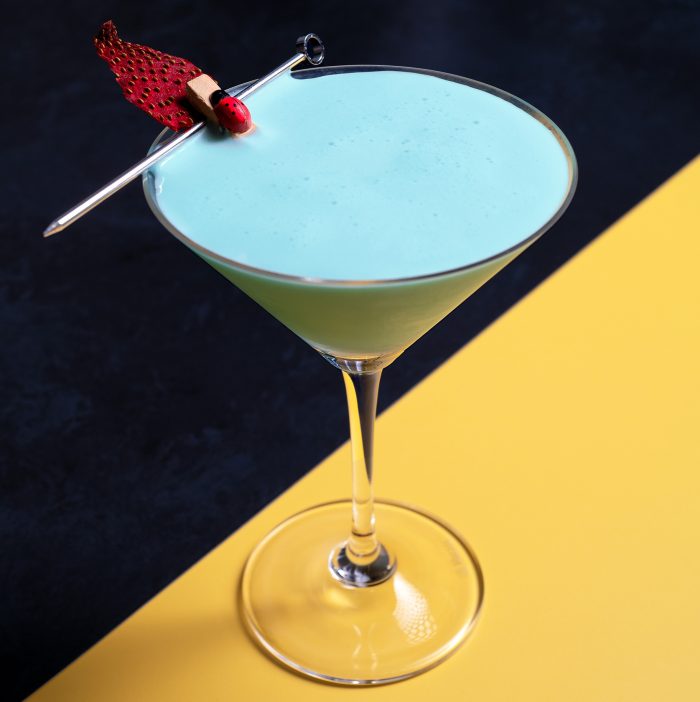Image of a blue creamy looking cocktail in martini glass called Blue bird dayz
