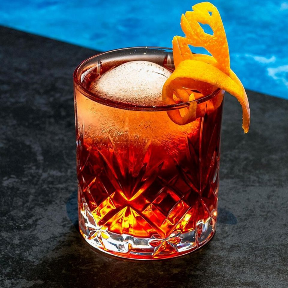 The Remarkable Negroni cocktail garnished with an orange twist made